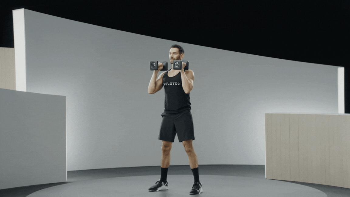 Peloton instructor Matty Maggiacomo demonstrates the thruster exercise