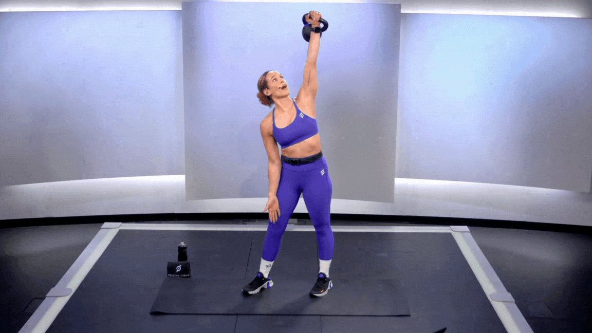 Peloton instructor Jess Sims demonstrating a kettlebell windmill with proper form as part of a list of kettlebell shoulder exercises