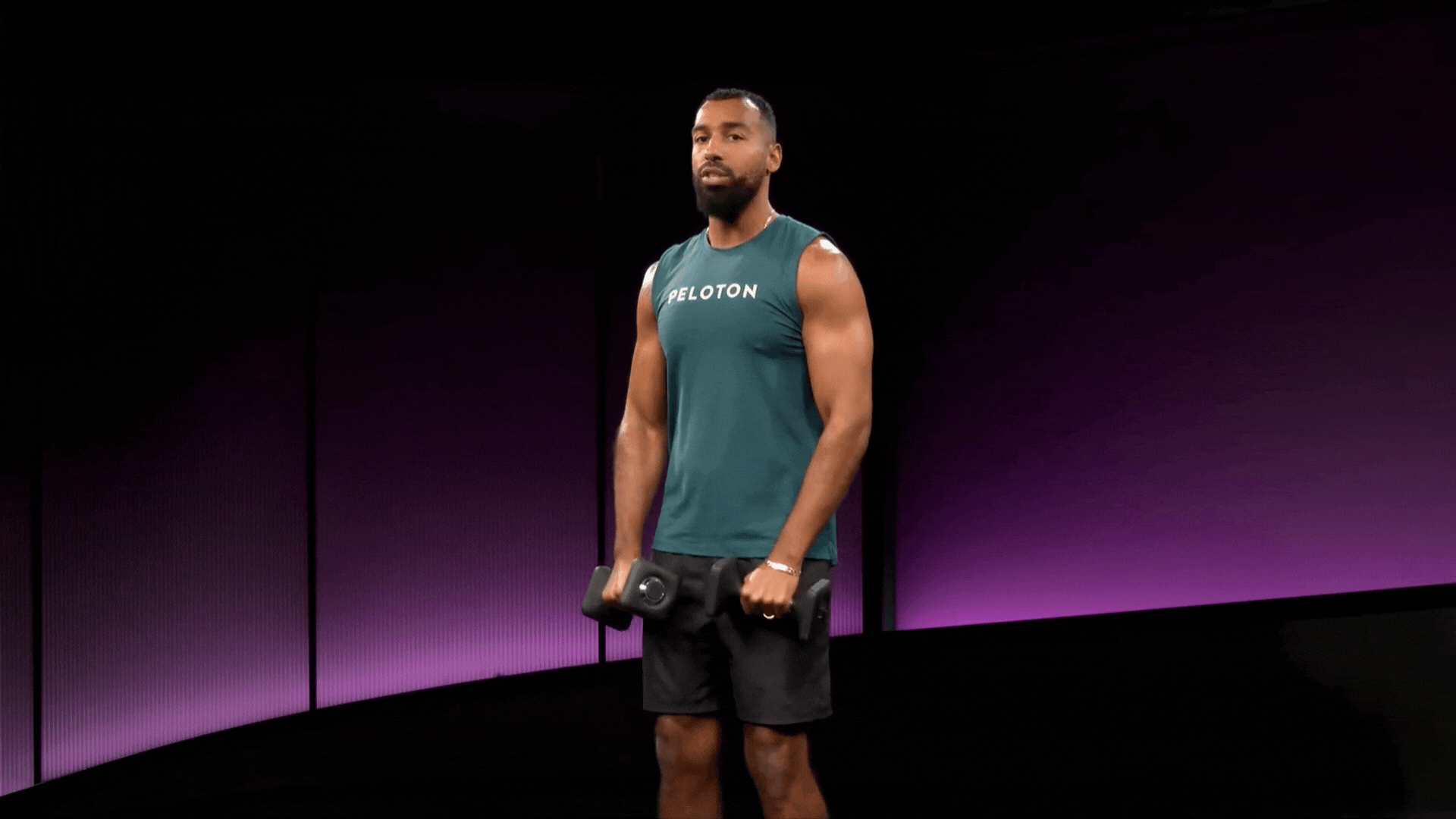 Man does a frontal raise, dumbbell shoulder exercises