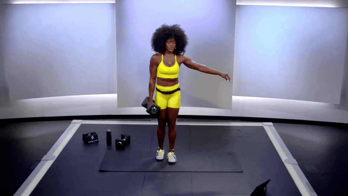 Peloton instructor Tunde Oyeneyin demonstrates a lateral lunge dumbbell leg exercise.