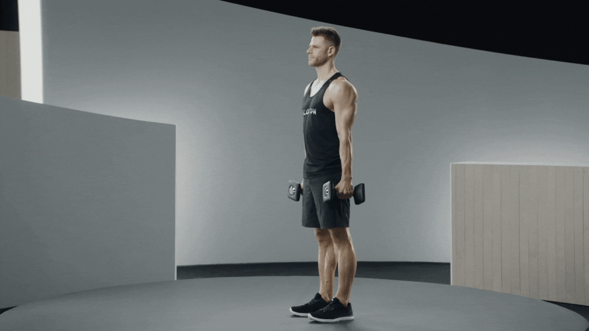 Peloton instructor Andy Speer demonstrates dumbbell triceps kickback form