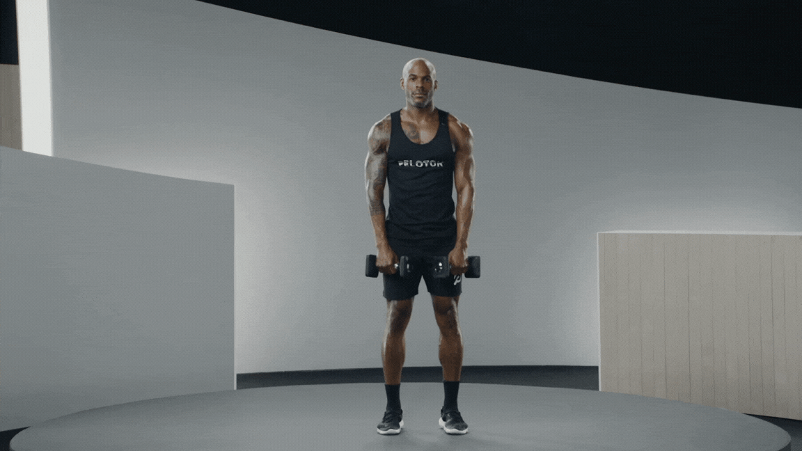 Peloton instructor Adrian Williams demonstrates a dumbbell upright row with proper form