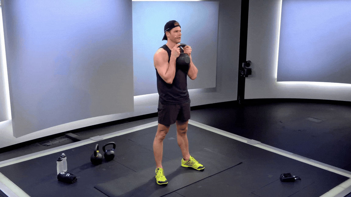 Peloton instructor Andy Speer doing a kettlebell goblet squat while teaching a kettlebell strength class