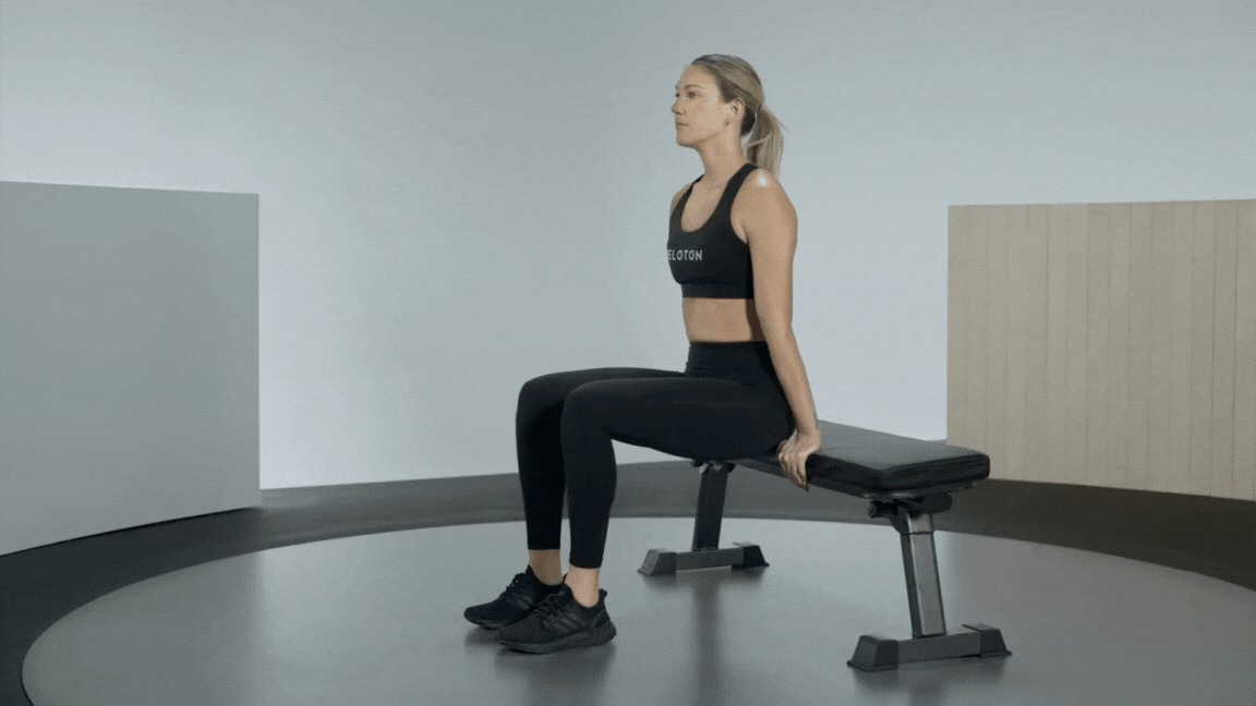 Peloton instructor Callie Gullickson demonstrates a bench triceps dip strength exercise with proper form.