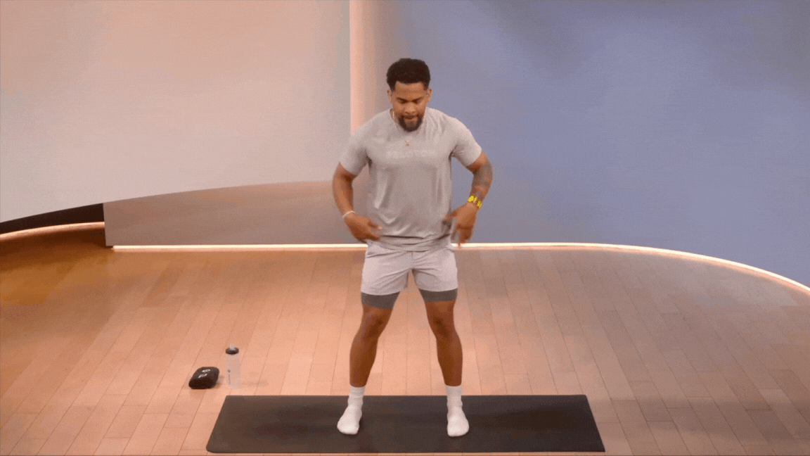 Peloton instructor Rad Lopez demonstrates a standing torso twist