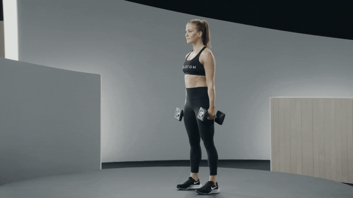 Peloton instructor Rebecca Kennedy demonstrates a dumbbell squat correctly