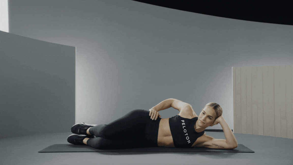 An instructor demonstrates a Clamshell exercise 