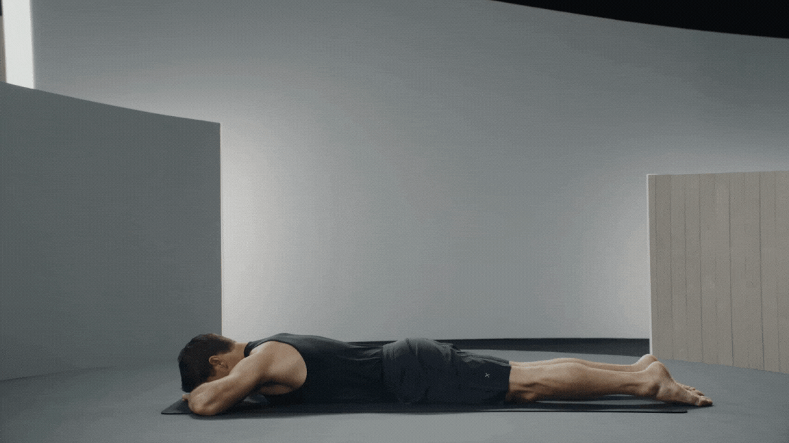 Peloton instructor Denis Morton demonstrates Sphinx pose