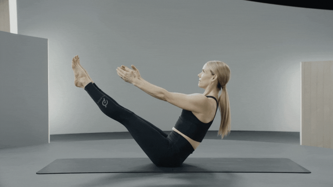 Peloton instructor Kristin McGee demonstrates a V-sit hold isometric exercise with proper form