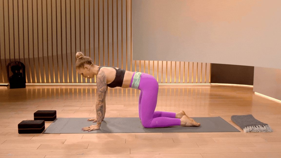 Peloton instructor Kirra Michel demonstrates the cat cow spinal mobility exercise.
