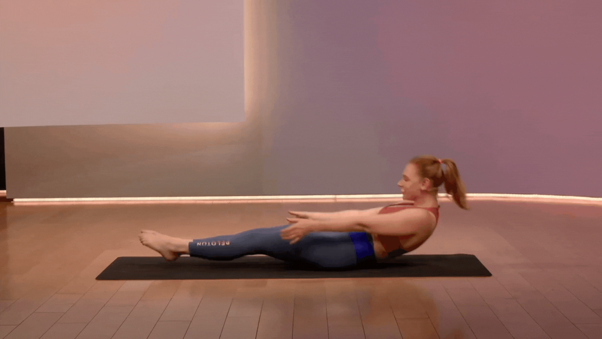 Anna Greenbeg doing a teaser, a pilates mat exercise