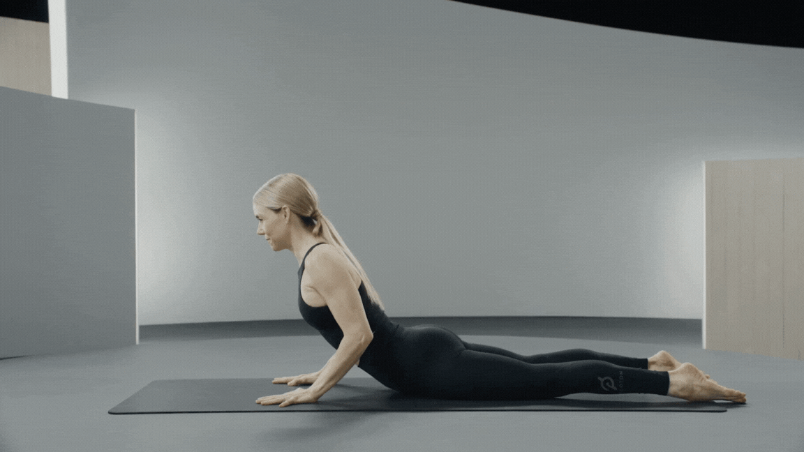 Peloton instructor Kristin McGee demonstrates a Pilates swan dive with proper form