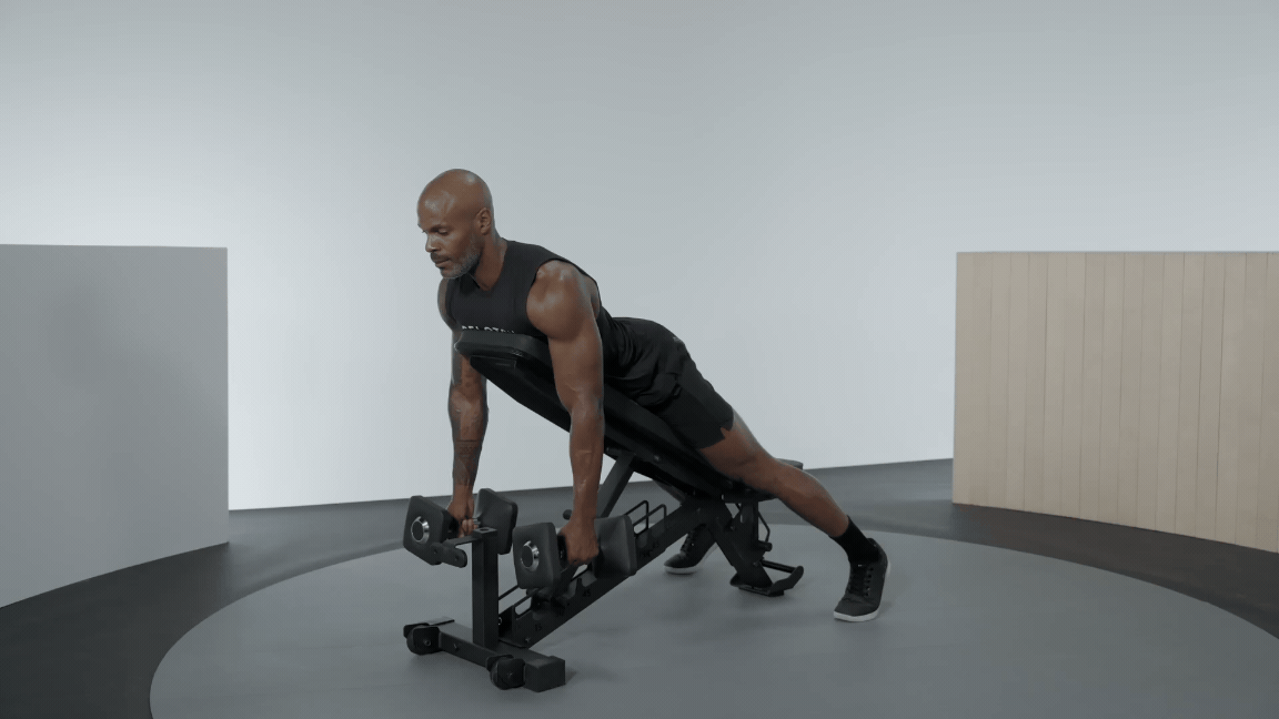 Adrian Williams demonstrates a chest-supported row on a workout bench