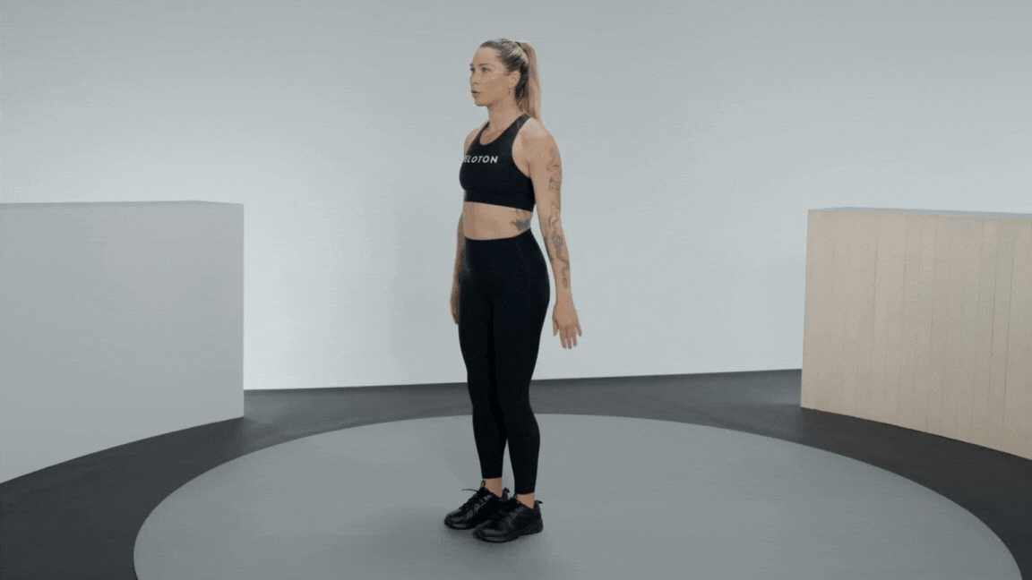 Instructor demonstrates a single leg squat 