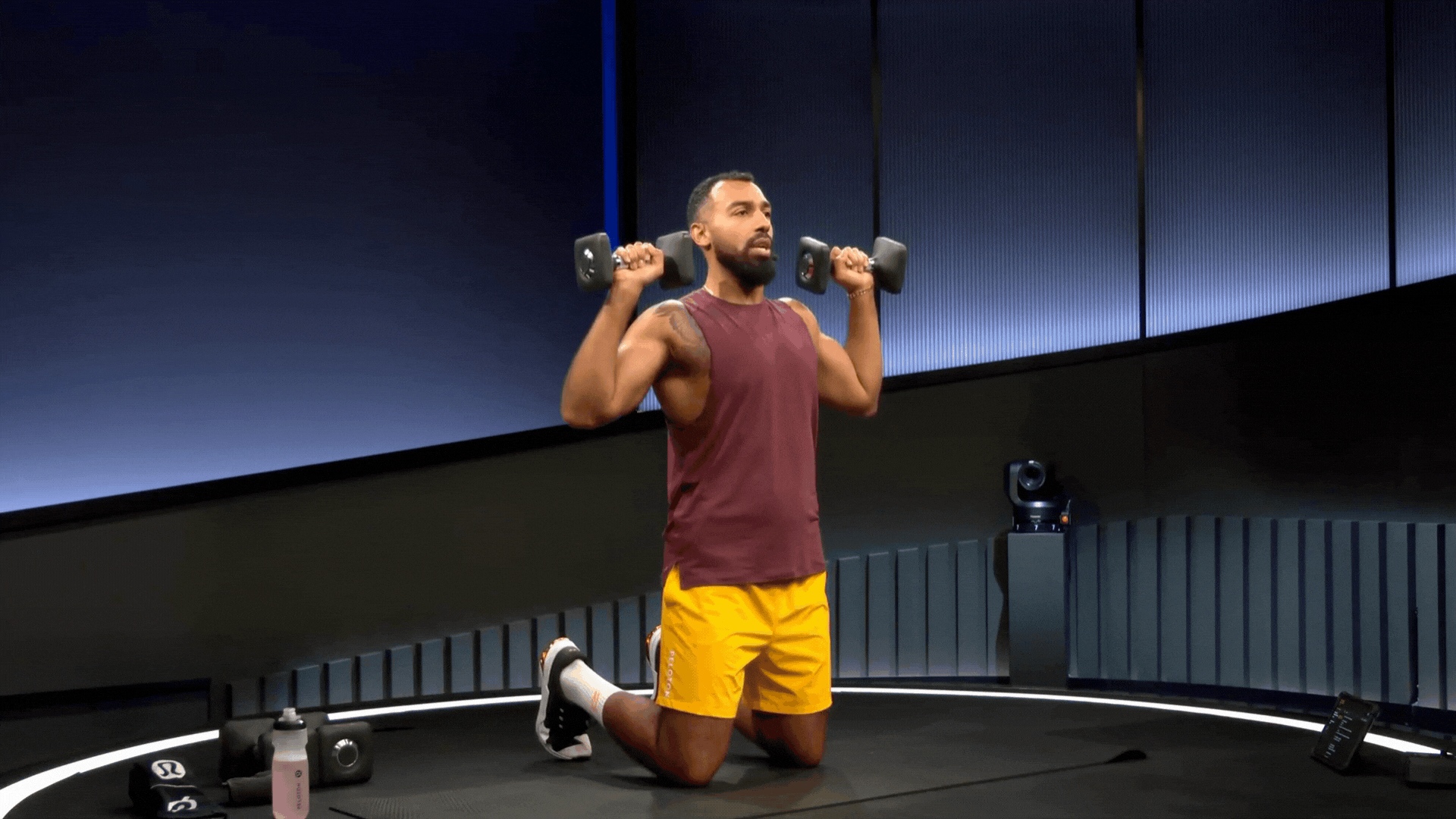 Man does an overhead press, a dumbbell shoulder exercise