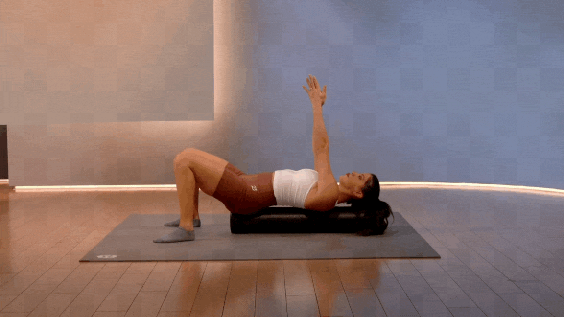 Peloton instructor Hannah Corbin demonstrates a foam roller chest expansion as a morning stretch