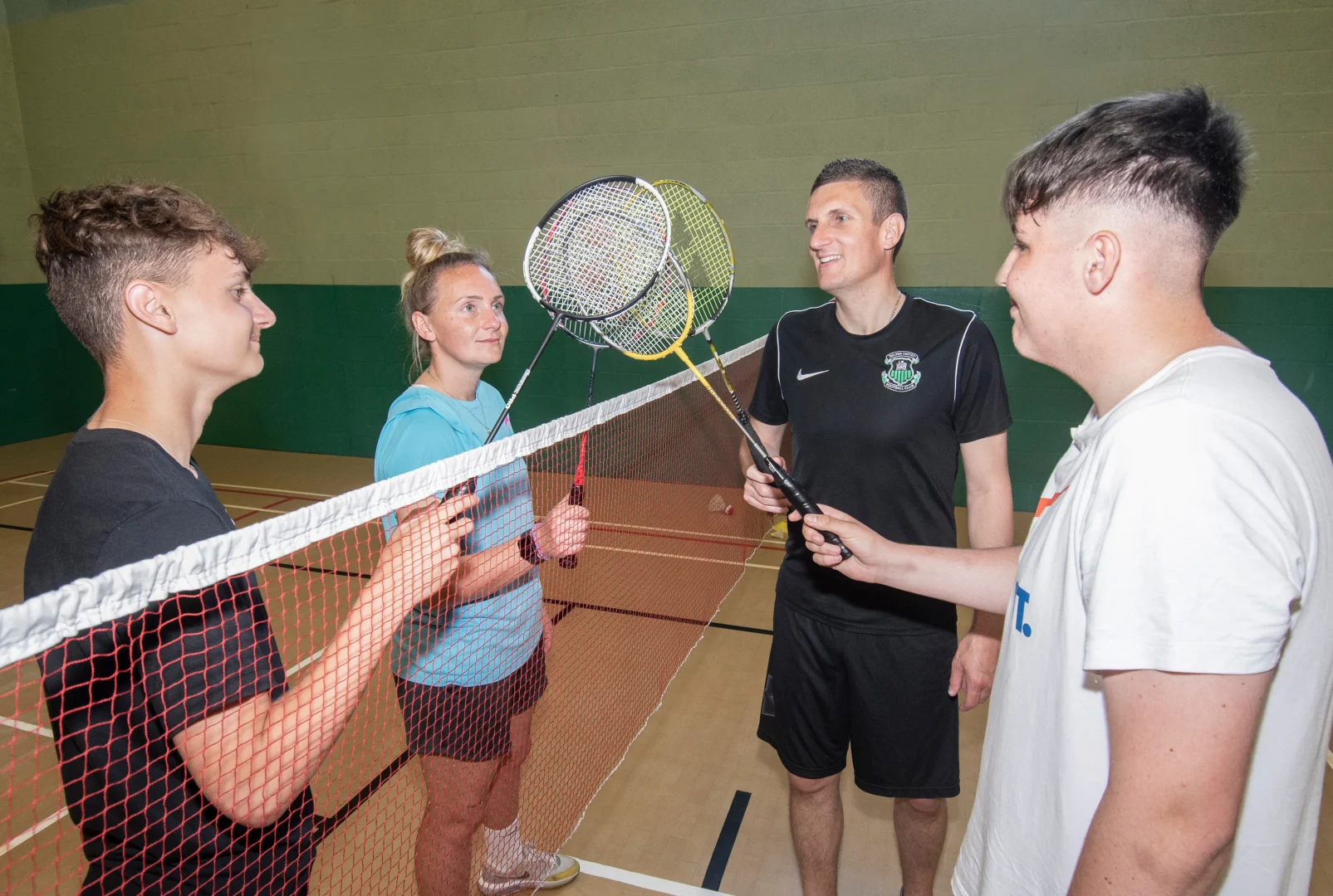 ADults Ting Rackets across net.jpg