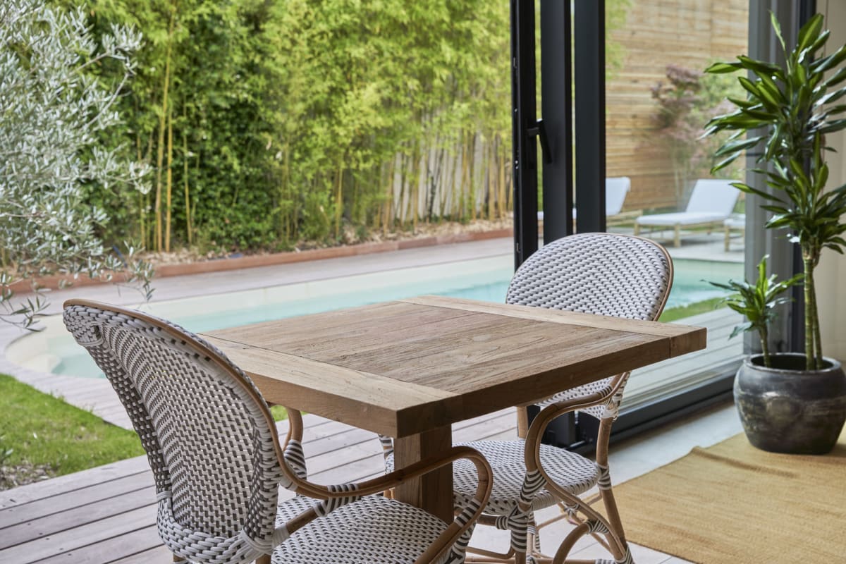 Lounge table overlooking the pool and bamboo