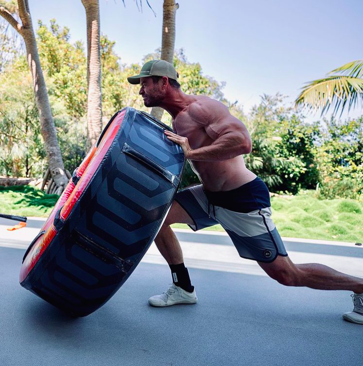 Chris Hemsworth muscles flipping tyre