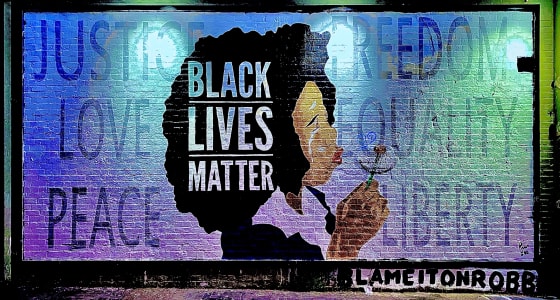 Black Lives Matter spelt out on a graffiti wall with an illustration of a black woman