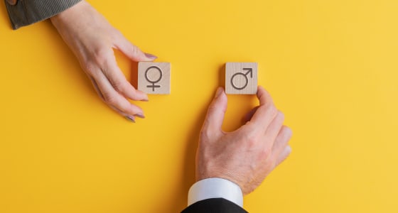 female and male hands holding wooden blocks.