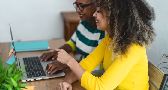 Two women looking at a laptop together