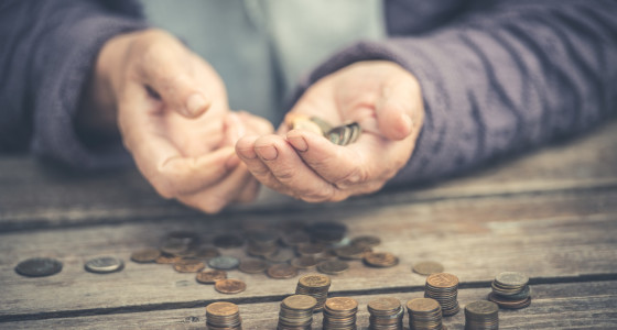 Pair of elderly hands holding some coins