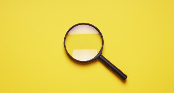 magnifying glass with a yellow background