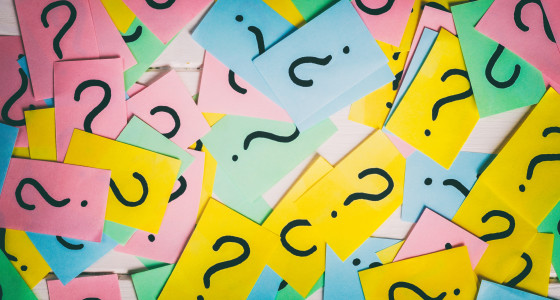 Brightly coloured post it notes with questions marks on