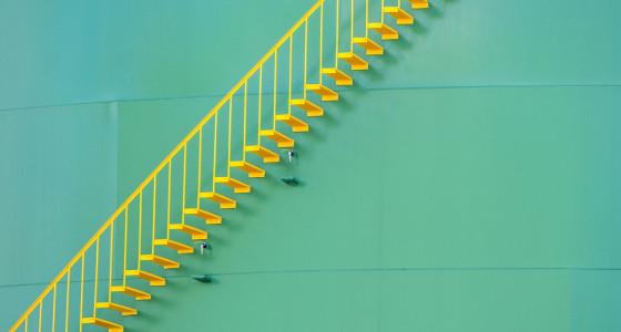 light green background with a straight yellow staircase in front