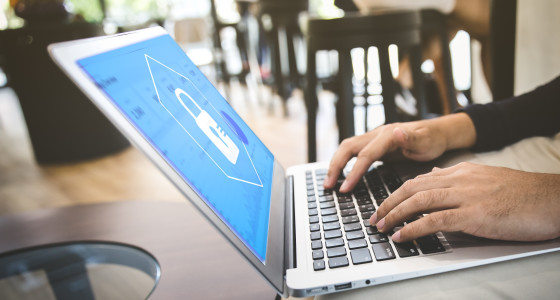 man on laptop screen showing blue background with padlock