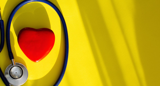 yellow background with red love heart and stethoscope