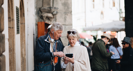 A retired couple exploring a city on holiday