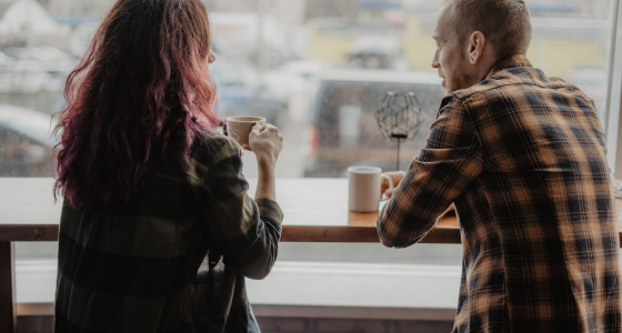 Couple drinking coffee and talking about money