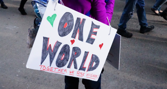 Protester carrying a sign which reads 