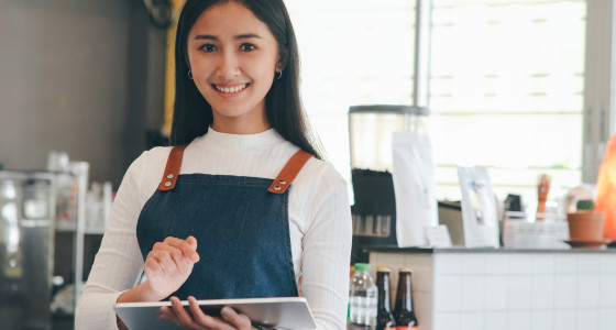 Young women working in a cafe as a barista