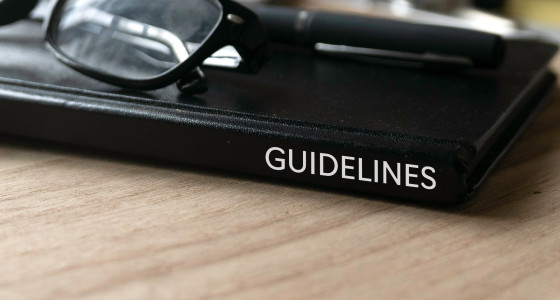 Black book with guidelines written on the side