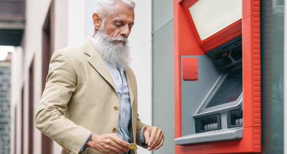 Older man at an ATM.