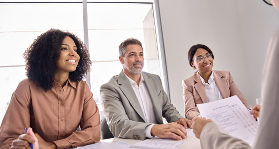 Three people interviewing a job candidate.