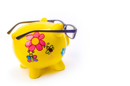 Yellow piggy bank wearing glasses.