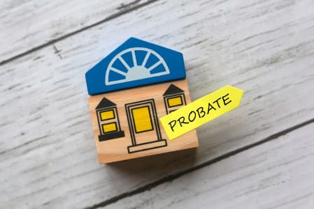 Toy house with 'probate' written on yellow sticky note.