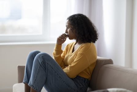 Young black women sitting on sofa