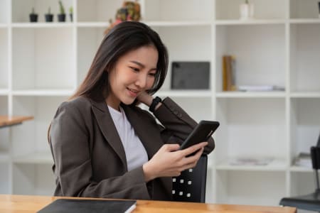 Happy asian woman using smart phone for business, online shopping, transfer money, financial, internet banking.