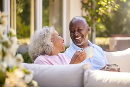 retired couple sitting outside on the sofa