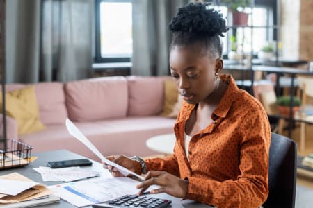 young woman calculating tax bill