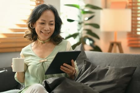 Smiling older woman using laptop