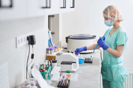 female-in-medical-suit-working-in-laboratory