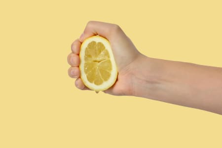 Hand squeezing a lemon