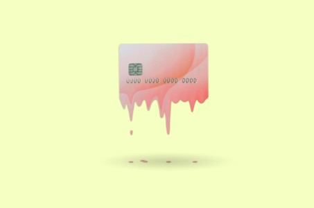 A pink credit card melting on a yellow background