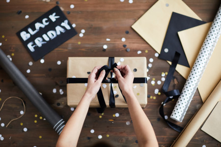 Woman packaging Black Friday gift.